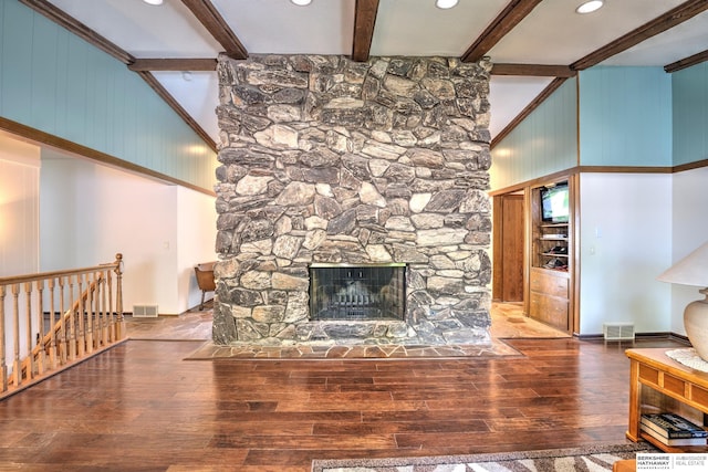 1915 S 131st Ave, Omaha, NE 68144 - unfurnished living room with hardwood / wood-style flooring, beamed ceiling, a stone fireplace, recessed lighting, and a towering ceiling