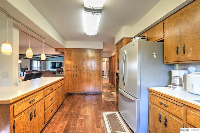 1915 S 131st Ave, Omaha, NE 68144 - kitchen featuring appliances with stainless steel finishes, dark wood finished floors, brown cabinetry, and light countertops
