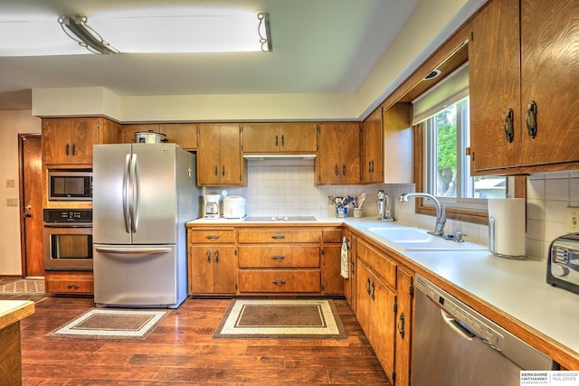 1915 S 131st Ave, Omaha, NE 68144 - kitchen with stainless steel appliances, a sink, dark wood-style floors, light countertops, and brown cabinets