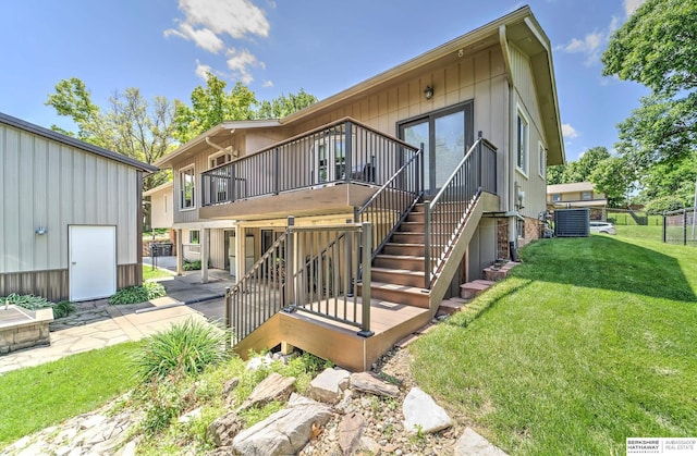 1915 S 131st Ave, Omaha, NE 68144 - view of front facade featuring a wooden deck, central AC, stairs, and a patio area