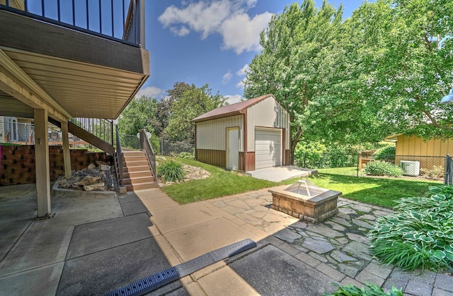 1915 S 131st Ave, Omaha, NE 68144 - view of patio with a fire pit, stairway, an outdoor structure, a garage, and cooling unit