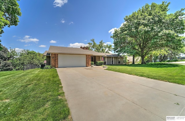 1915 S 131st Ave, Omaha, NE 68144 - view of front of home featuring an attached garage, brick siding, driveway, a front yard, and a chimney