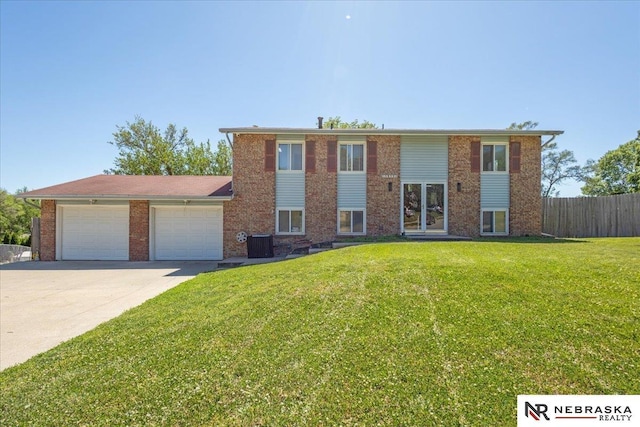 1511 Lorraine Ave, Bellevue, NE 68005 - raised ranch featuring a garage, driveway, central AC unit, and brick siding