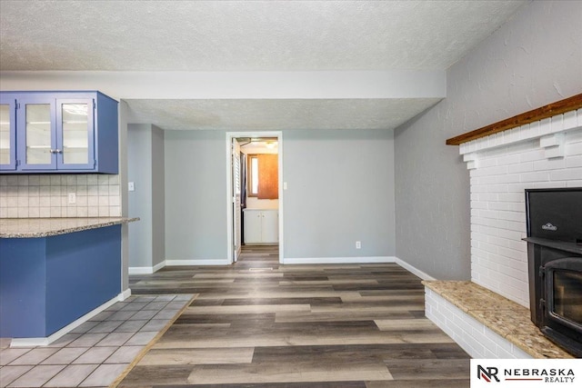 1511 Lorraine Ave, Bellevue, NE 68005 - unfurnished living room with a textured ceiling, wood finished floors, a fireplace, and baseboards