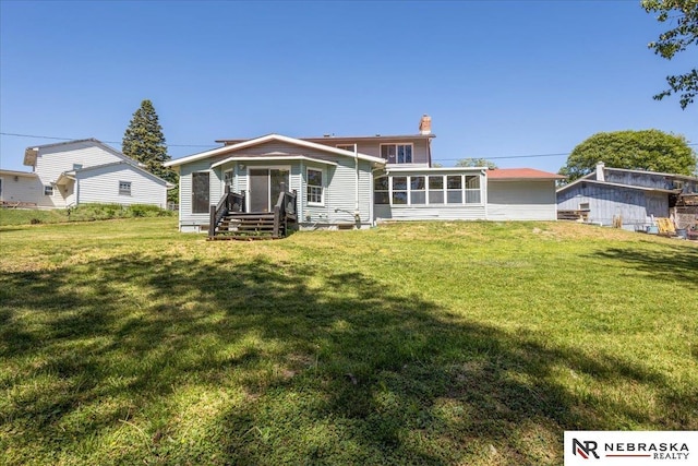 1511 Lorraine Ave, Bellevue, NE 68005 - rear view of property with a chimney, a lawn, and a sunroom