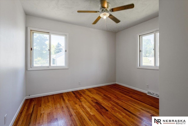 1511 Lorraine Ave, Bellevue, NE 68005 - spare room with plenty of natural light, wood finished floors, a ceiling fan, and baseboards