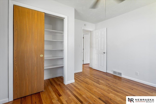 1511 Lorraine Ave, Bellevue, NE 68005 - unfurnished bedroom featuring baseboards, wood finished floors, a closet, and a ceiling fan