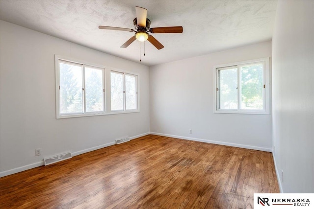 1511 Lorraine Ave, Bellevue, NE 68005 - spare room with healthy amount of natural light, wood finished floors, and baseboards