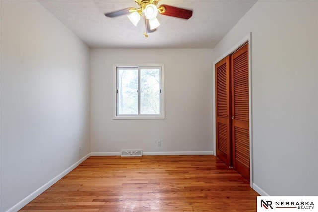 1511 Lorraine Ave, Bellevue, NE 68005 - unfurnished bedroom featuring a closet, light wood-type flooring, baseboards, and a ceiling fan