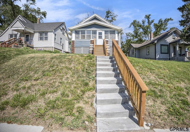 4315 N 39th St, Omaha, NE 68111 - view of front of property with stairs, a sunroom, and a front lawn