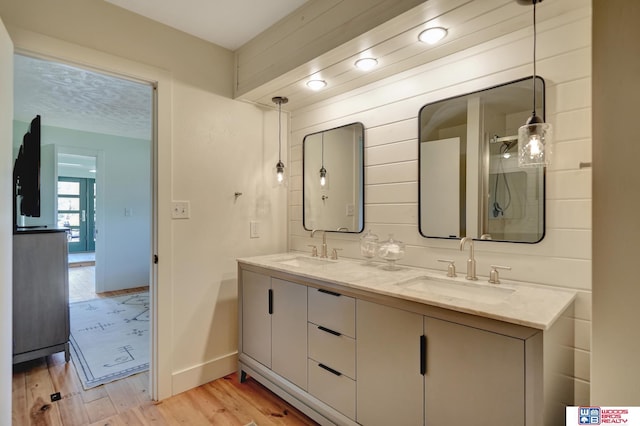 209 N Maloney Dr, North Platte, NE 69101 - bathroom with wood finished floors, double vanity, and baseboards