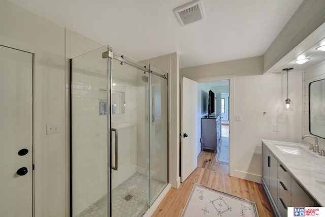 209 N Maloney Dr, North Platte, NE 69101 - bathroom with vanity, wood finished floors, a shower stall, and baseboards