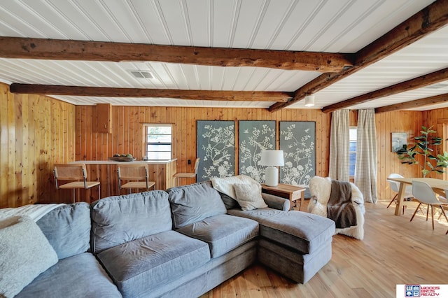 209 N Maloney Dr, North Platte, NE 69101 - living area featuring wood walls, beamed ceiling, and light wood finished floors