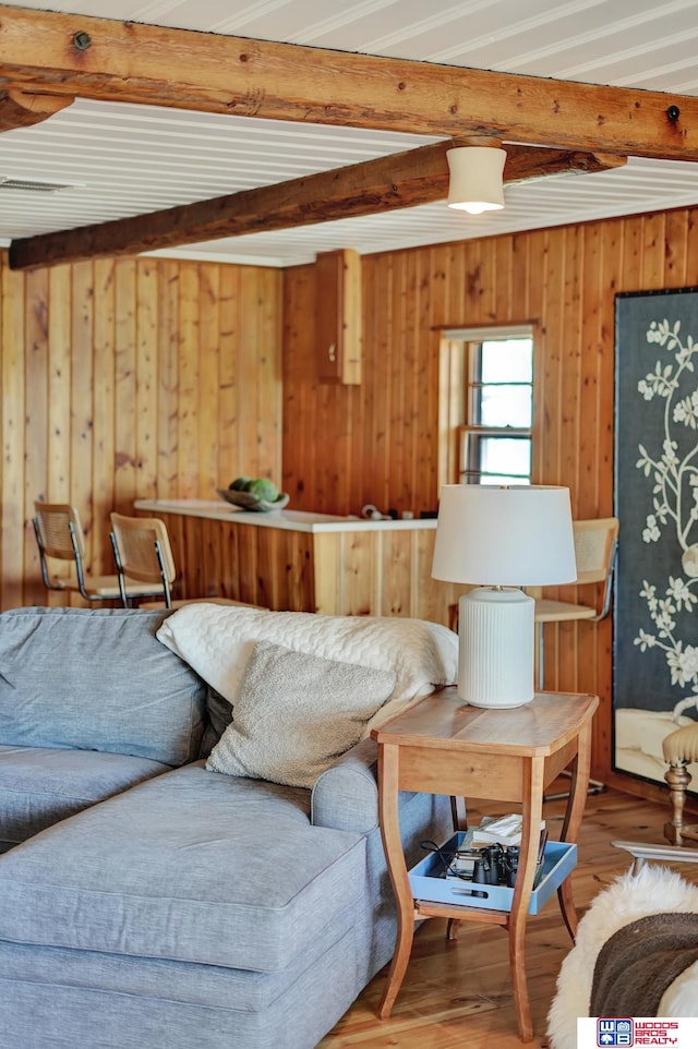 209 N Maloney Dr, North Platte, NE 69101 - living area featuring beamed ceiling, wooden walls, and wood finished floors