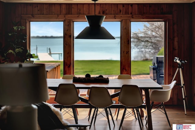 209 N Maloney Dr, North Platte, NE 69101 - dining room featuring a water view, wood walls, and wood finished floors