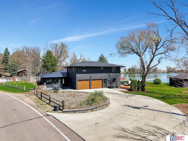 209 N Maloney Dr, North Platte, NE 69101 - view of front of property featuring a water view, a garage, and concrete driveway