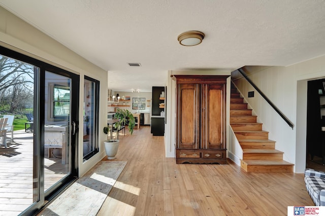 209 N Maloney Dr, North Platte, NE 69101 - entrance foyer featuring stairs, light wood-style floors, and a textured ceiling