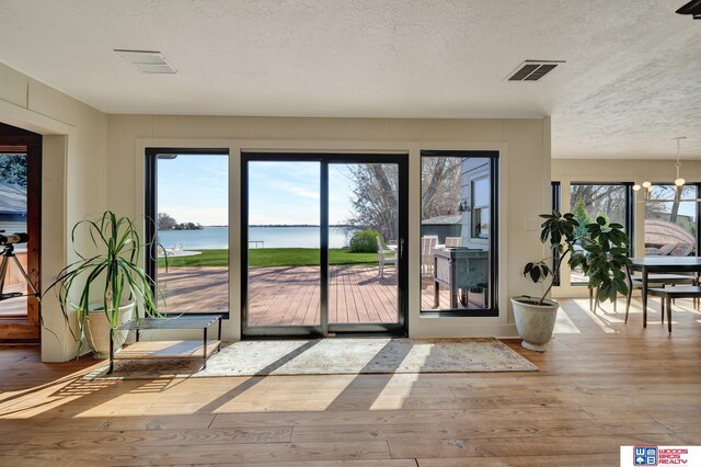 209 N Maloney Dr, North Platte, NE 69101 - doorway with wood-type flooring, a water view, and a textured ceiling