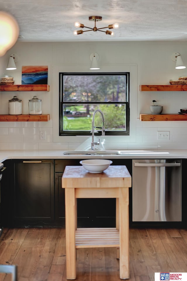 209 N Maloney Dr, North Platte, NE 69101 - kitchen featuring open shelves, dishwasher, light wood-type flooring, light countertops, and a textured ceiling