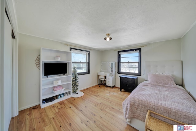 209 N Maloney Dr, North Platte, NE 69101 - bedroom with light wood-style flooring, baseboards, and a textured ceiling