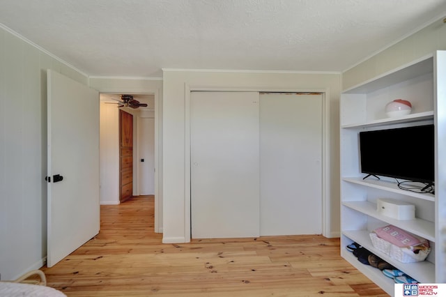 209 N Maloney Dr, North Platte, NE 69101 - bedroom with crown molding, a closet, and light wood-style floors