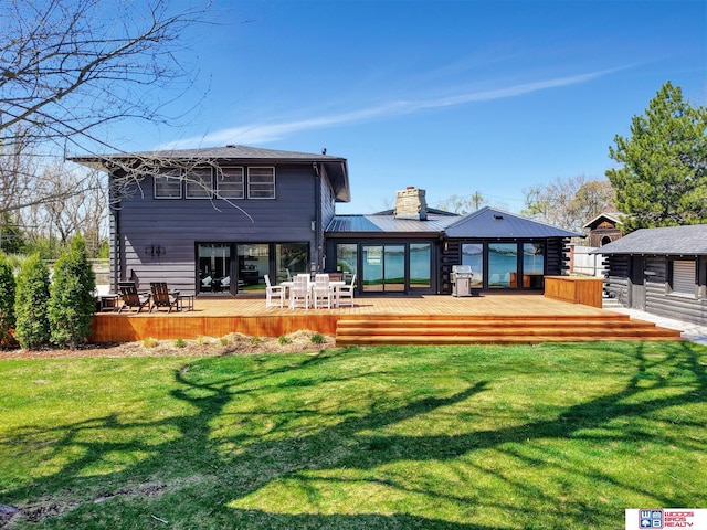 209 N Maloney Dr, North Platte, NE 69101 - back of house featuring a deck, a chimney, a lawn, and outdoor dining area