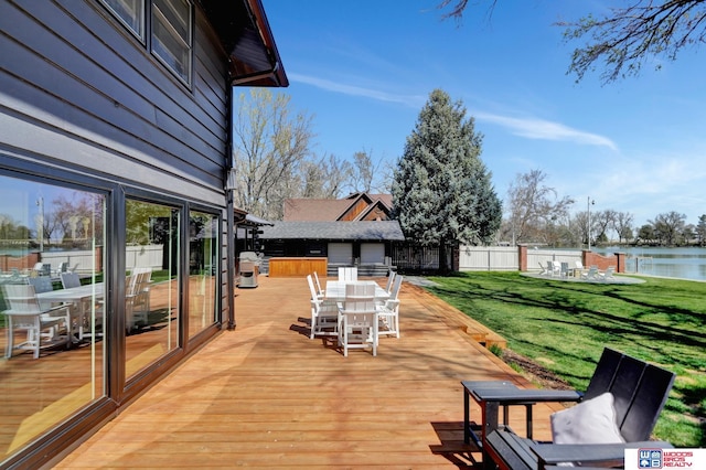 209 N Maloney Dr, North Platte, NE 69101 - wooden deck with outdoor dining space and a water view