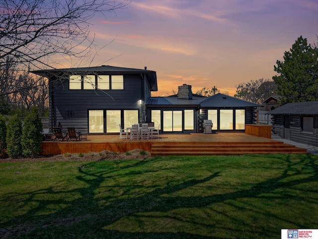 209 N Maloney Dr, North Platte, NE 69101 - back of property featuring a chimney, a yard, and a deck