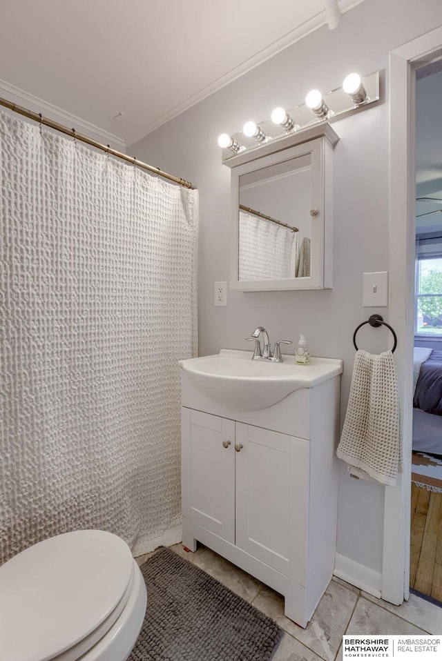 4332 Vinton St, Omaha, NE 68105 - bathroom featuring vanity, ornamental molding, toilet, curtained shower, and tile patterned flooring
