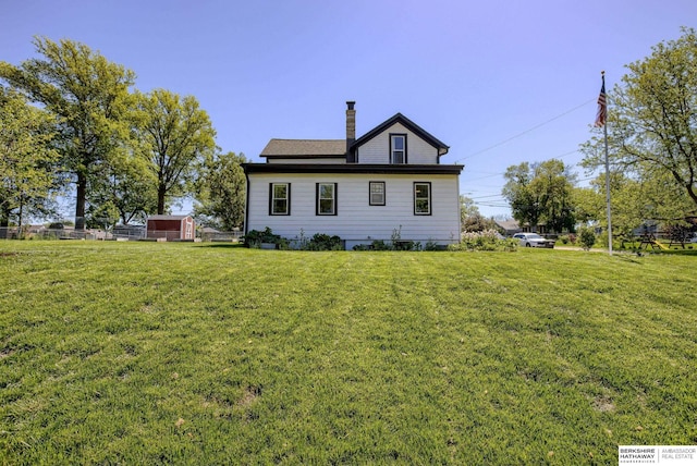4332 Vinton St, Omaha, NE 68105 - back of house featuring a chimney and a lawn