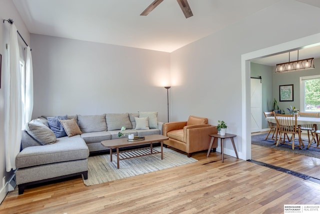 4332 Vinton St, Omaha, NE 68105 - living room with a barn door, light wood-style flooring, and ceiling fan