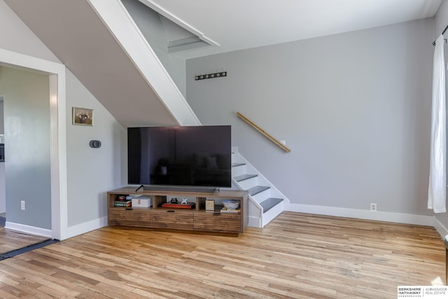 4332 Vinton St, Omaha, NE 68105 - unfurnished living room featuring wood finished floors, baseboards, and stairs