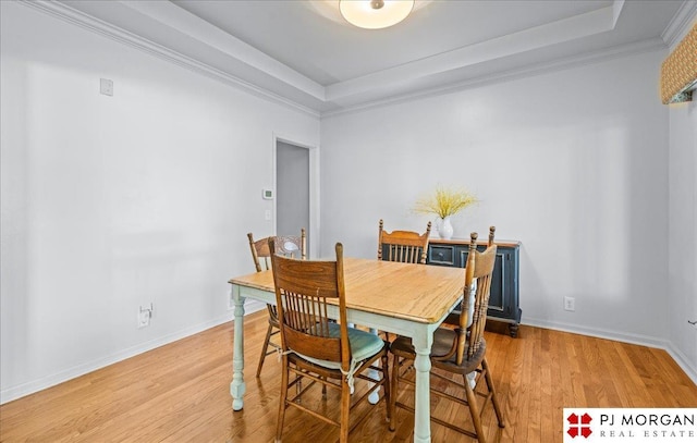 5517 S 174th Ave, Omaha, NE 68135 - dining area with a tray ceiling, light wood-style flooring, baseboards, and crown molding
