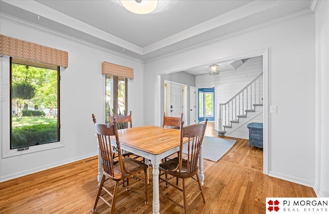 5517 S 174th Ave, Omaha, NE 68135 - dining area featuring light wood finished floors, stairs, crown molding, and baseboards