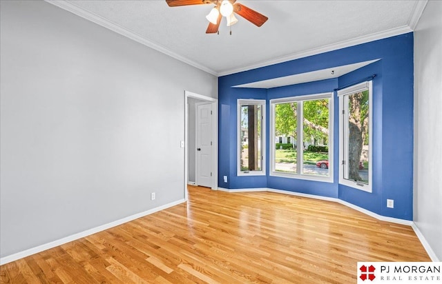 5517 S 174th Ave, Omaha, NE 68135 - spare room featuring a ceiling fan, baseboards, light wood-style floors, and ornamental molding