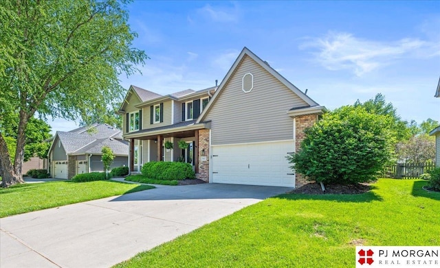 5517 S 174th Ave, Omaha, NE 68135 - traditional home featuring concrete driveway, a front lawn, brick siding, and an attached garage