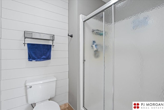 5517 S 174th Ave, Omaha, NE 68135 - full bathroom with a stall shower, toilet, and wooden walls