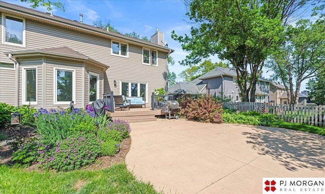 5517 S 174th Ave, Omaha, NE 68135 - rear view of property with a wooden deck, a chimney, and a patio