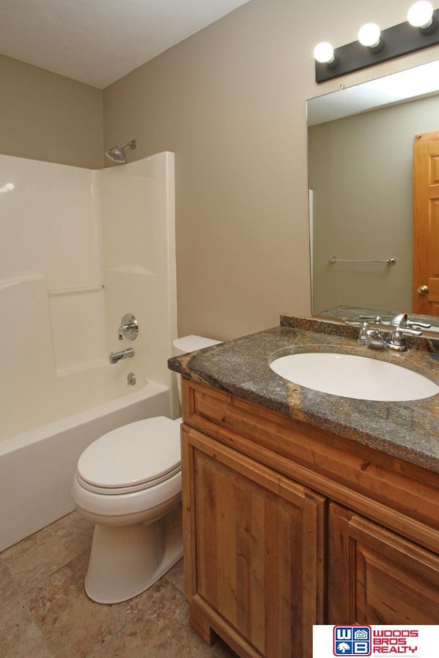 1912 SW 25th St, Lincoln, NE 68522 - full bath featuring vanity, toilet, shower / washtub combination, and stone finish flooring