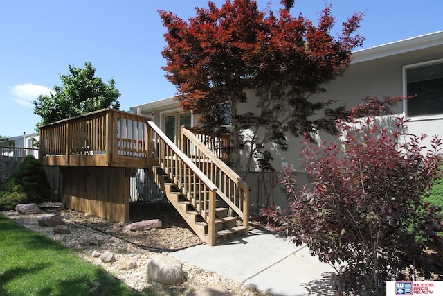 1912 SW 25th St, Lincoln, NE 68522 - view of side of property with stairs, a wooden deck, and stucco siding