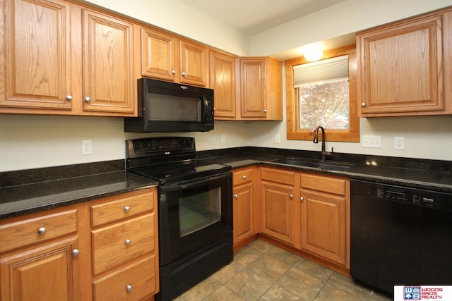 1912 SW 25th St, Lincoln, NE 68522 - kitchen with black appliances, a sink, and dark stone counters