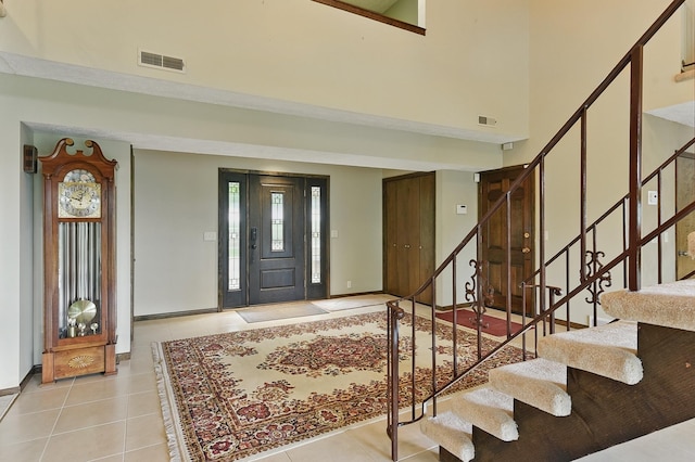 2564 County Road 12, Fremont, NE 68025 - entrance foyer featuring light tile patterned flooring, stairway, a high ceiling, and baseboards