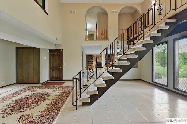2564 County Road 12, Fremont, NE 68025 - foyer entrance featuring tile patterned floors, stairway, a high ceiling, and baseboards