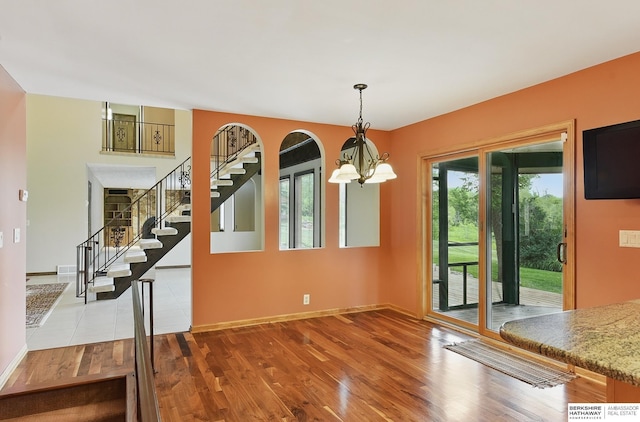 2564 County Road 12, Fremont, NE 68025 - unfurnished dining area with a chandelier, wood finished floors, stairway, and baseboards