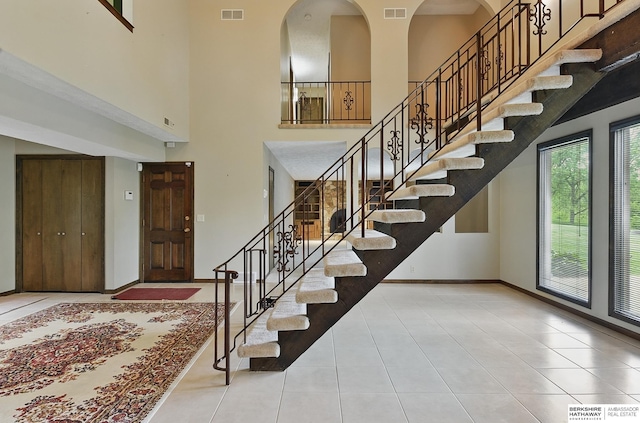 2564 County Road 12, Fremont, NE 68025 - stairway featuring a high ceiling, tile patterned floors, and baseboards