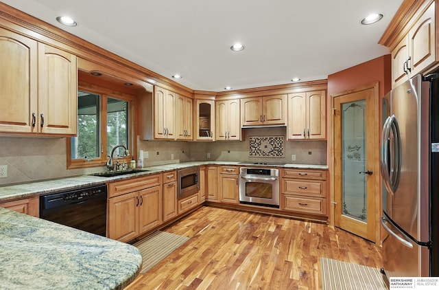 2564 County Road 12, Fremont, NE 68025 - kitchen with black appliances, a sink, light wood finished floors, glass insert cabinets, and decorative backsplash