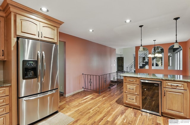 2564 County Road 12, Fremont, NE 68025 - kitchen with stainless steel fridge, beverage cooler, light wood-style flooring, hanging light fixtures, and recessed lighting