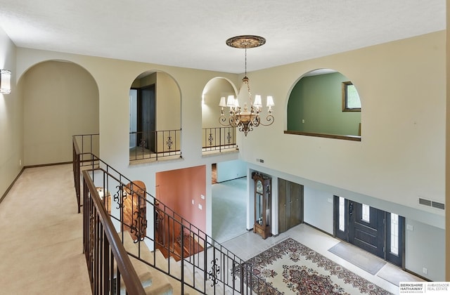 2564 County Road 12, Fremont, NE 68025 - carpeted entryway featuring a chandelier, a textured ceiling, and baseboards