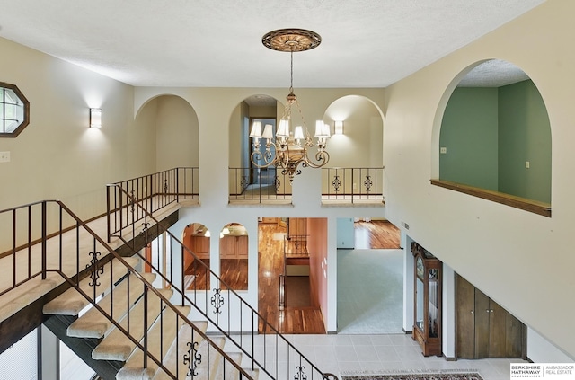 2564 County Road 12, Fremont, NE 68025 - staircase featuring tile patterned flooring, a chandelier, and carpet flooring