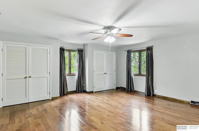2564 County Road 12, Fremont, NE 68025 - unfurnished bedroom featuring multiple closets, wood finished floors, and a ceiling fan